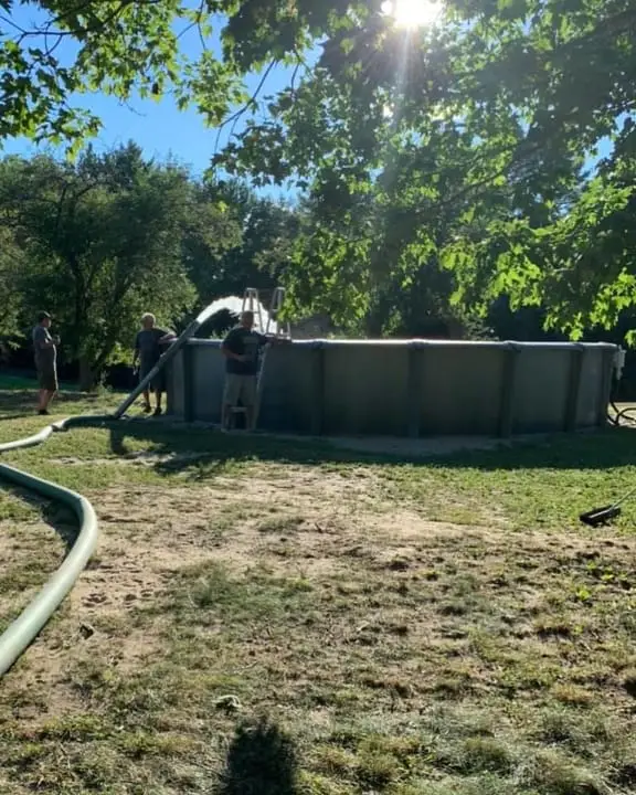 fire hose filling swimming pool