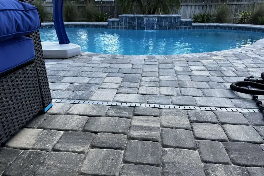 Having a deck drain between the pool and your home can assist with managing swimming pool overflows.