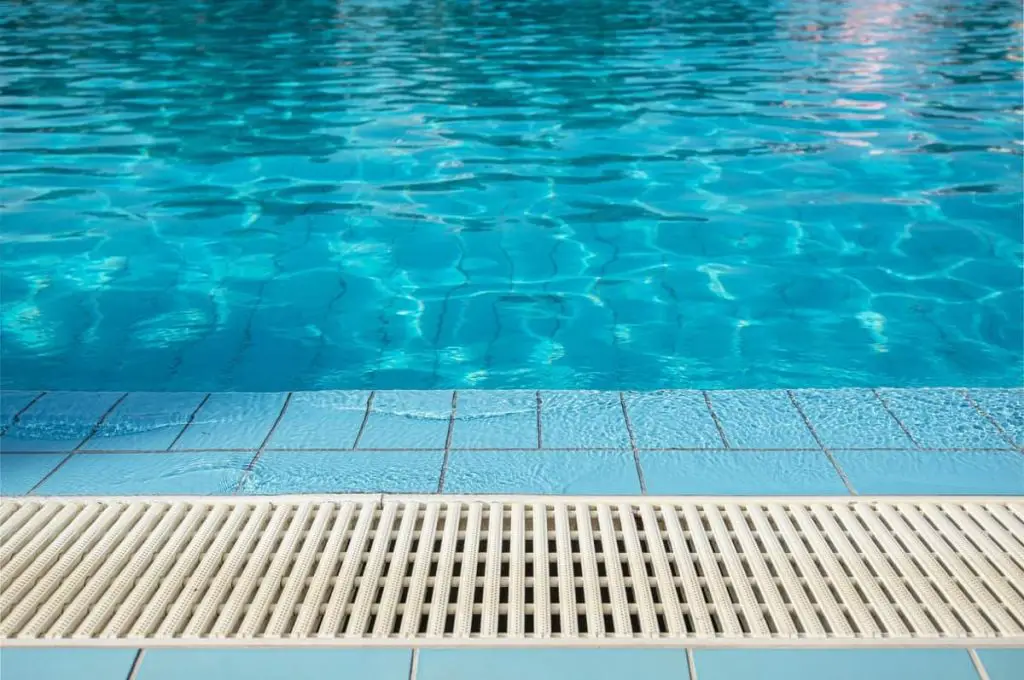 Swimming pool overflows into drain.