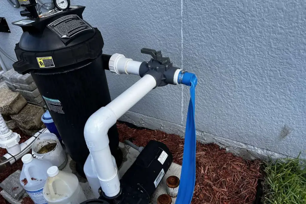 Most pumps or piping includes a spigot on install for draining swimming pools.