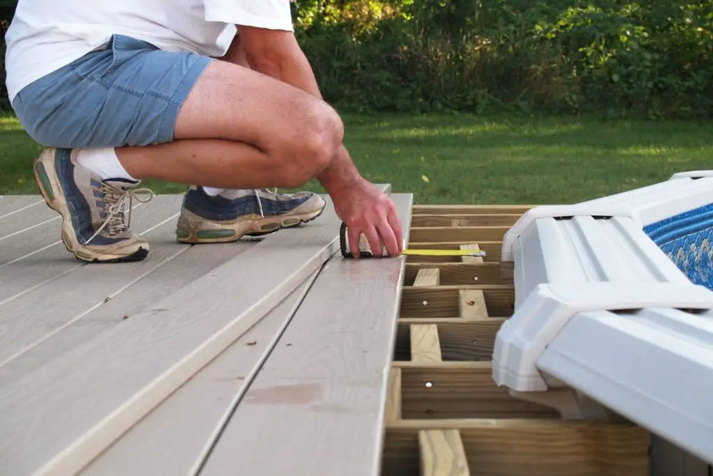 Measuring out a DIY above ground pool deck.