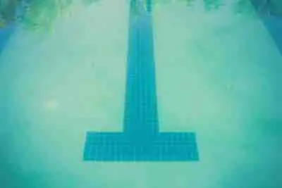 Lane markers are seen at the bottom of a murky, dirty pool