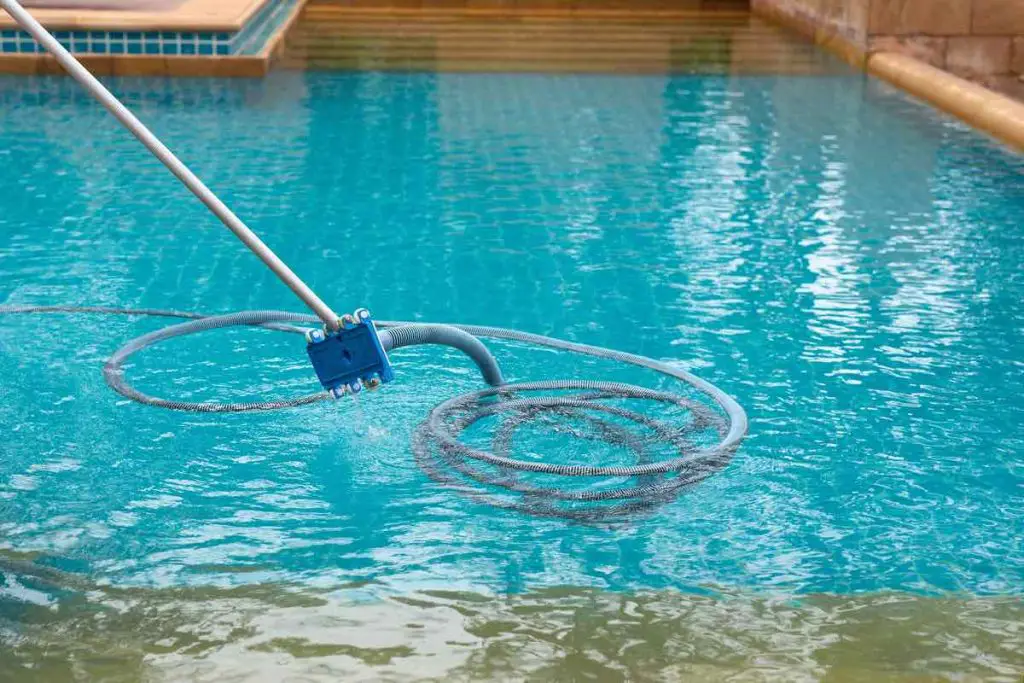 Pool vacuum cleaning dirty in bottom of swimming pool