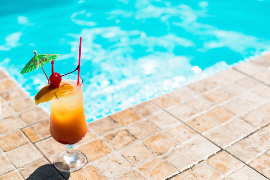The orange cocktail near the swimming pool