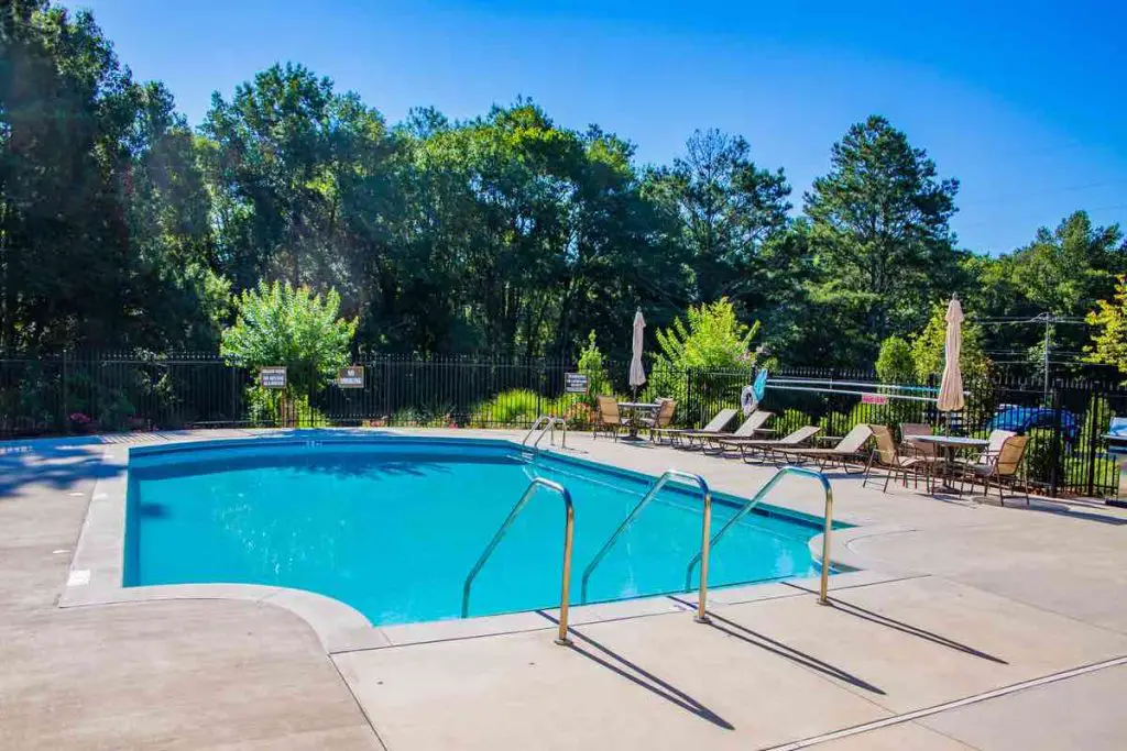 Small Blue Swimming Pool with Concrete Deck