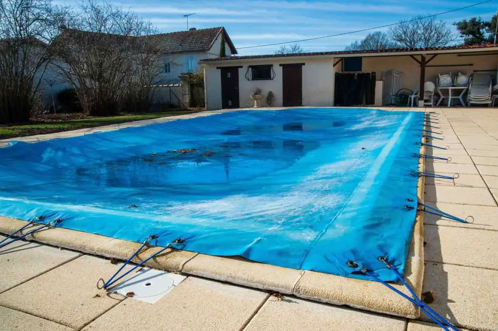 Pool protected by a pool cover during winter months