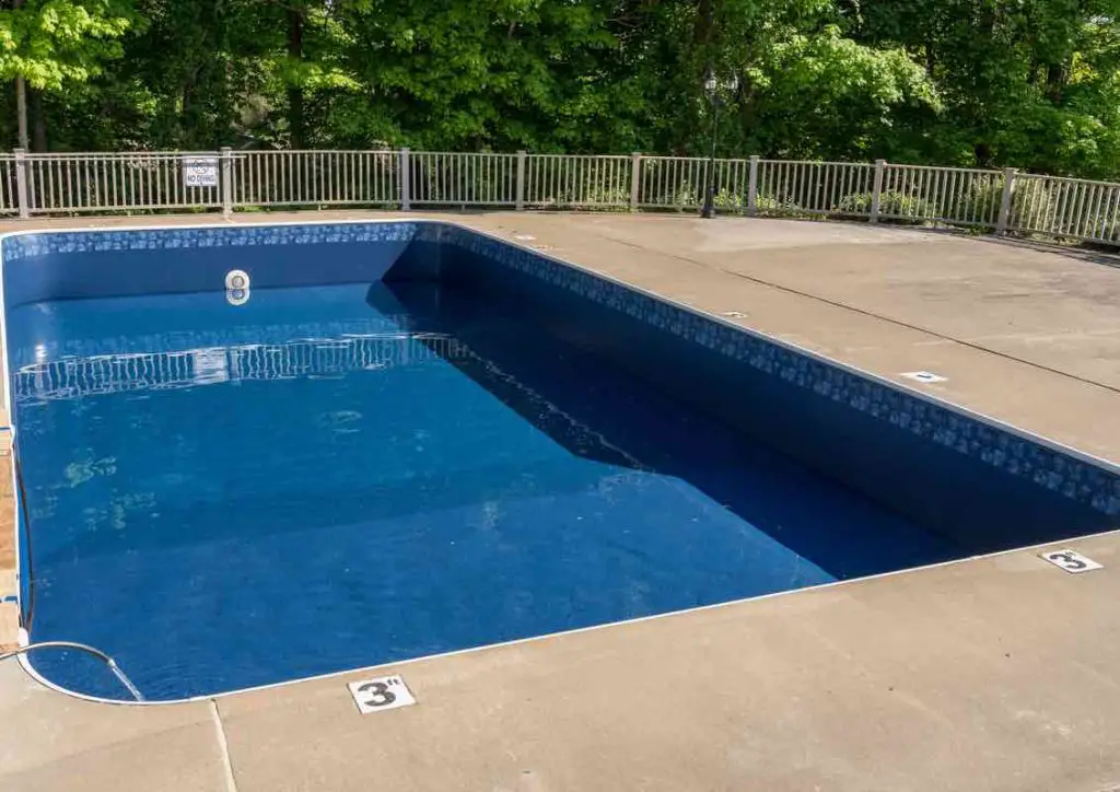 In ground swimming pool with new vinyl liner being refilled with water ready for use