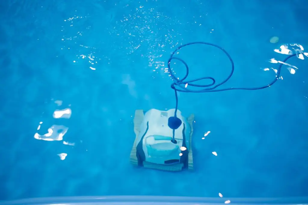 The robot is cleaning the pool. Maintenance pool concept.